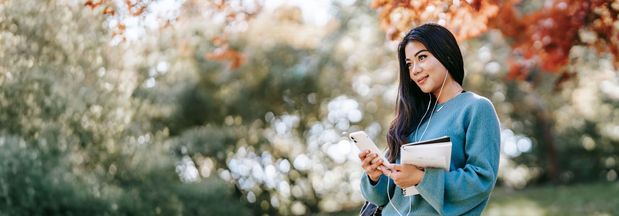 A student checking her Australian visa progress on her phone between classes